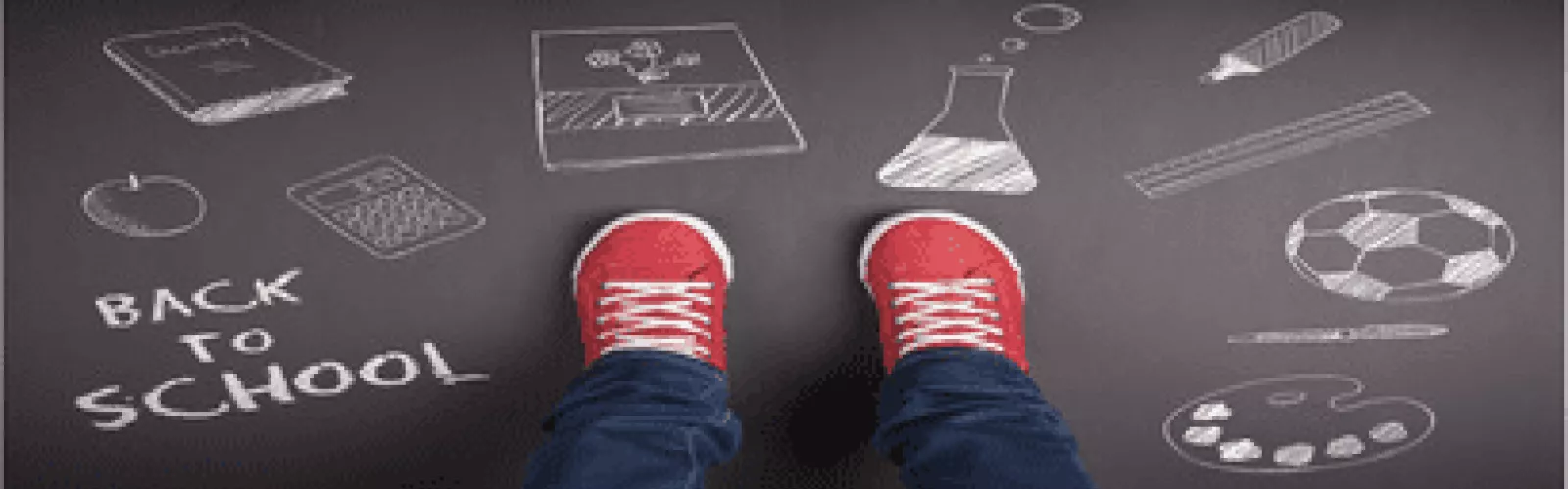two red shoes on blacktop with chalk drawings and text "Back to School"