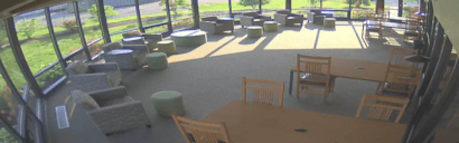 Glassed-in room with tables and chairs for quiet study